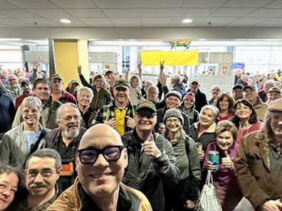 Attendees of expo gathered in convention all taking a selfie with Darren Bush, owner of Rutabaga Paddlesports